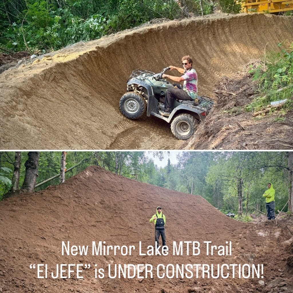 El Jefe under construction: a builder drives an ATV across a tall dirt berm, and two workers stand on a big dirt jump