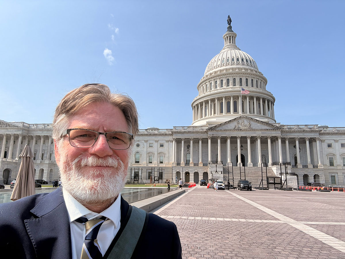 CMBR executive director Will Taygan standing in front of the U.S. Capitol in Washington, D.C.